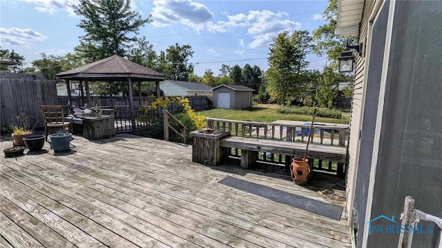 wooden deck with a storage shed and a gazebo