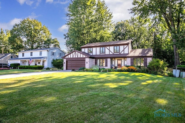 view of front of house with a garage and a front yard