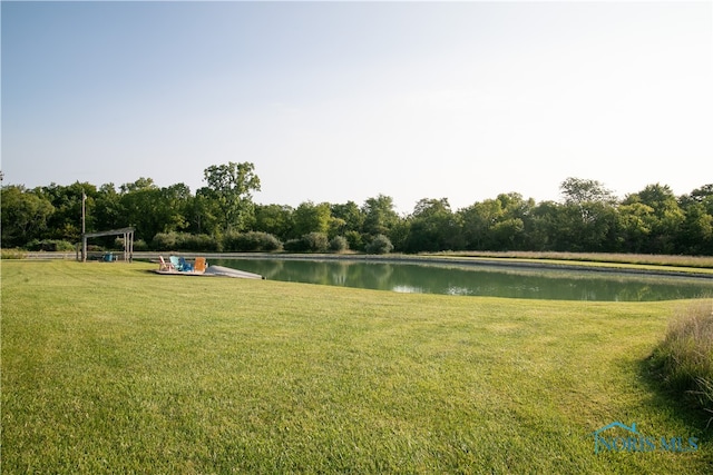 view of home's community featuring a water view and a yard