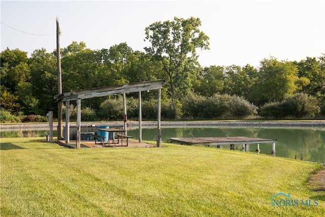 view of home's community featuring a lawn, a pergola, and a water view