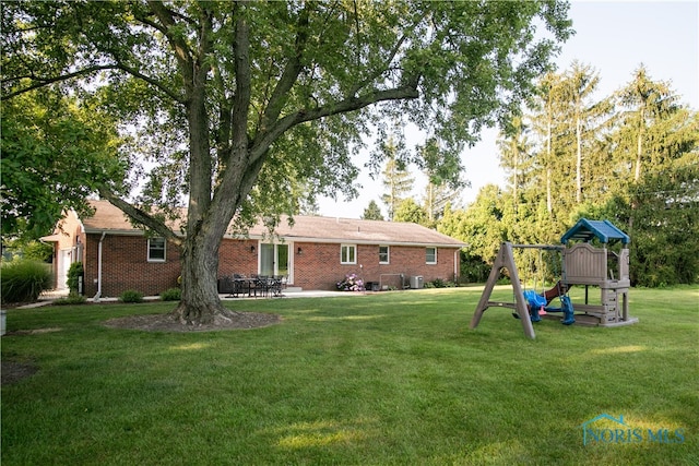 exterior space with a lawn and a playground