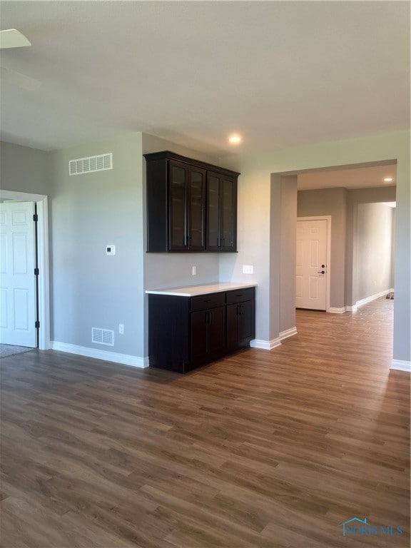 kitchen featuring dark brown cabinetry and wood-type flooring