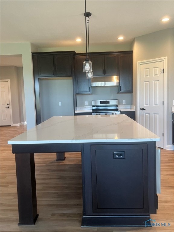 kitchen featuring a kitchen island, decorative light fixtures, light hardwood / wood-style floors, and stainless steel range oven