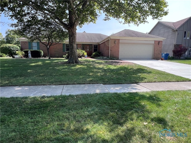 single story home featuring a garage and a front lawn