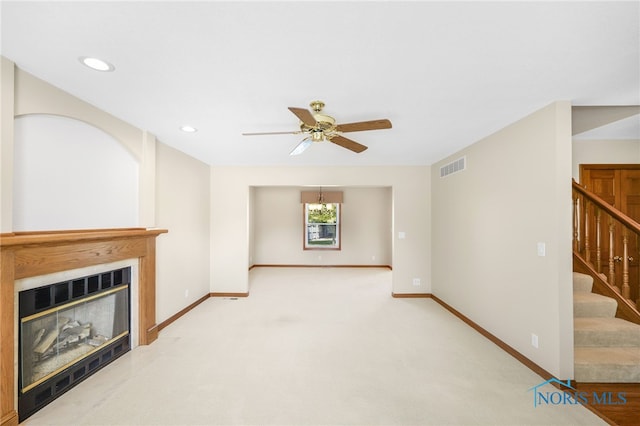 living room with light colored carpet and ceiling fan