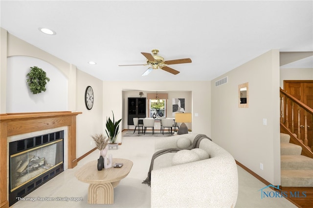 living room with light colored carpet and ceiling fan