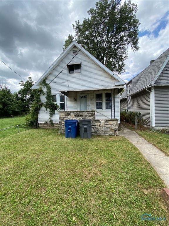 back of property with a lawn