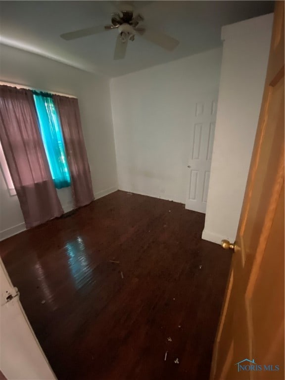 spare room featuring ceiling fan and hardwood / wood-style flooring