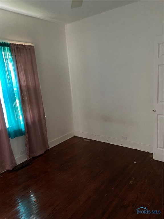 spare room featuring dark hardwood / wood-style floors