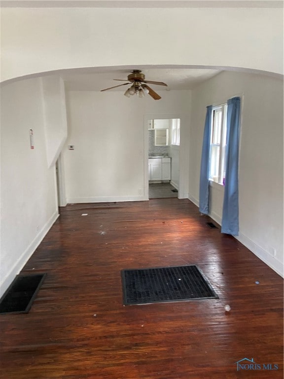 unfurnished living room featuring ceiling fan and wood-type flooring