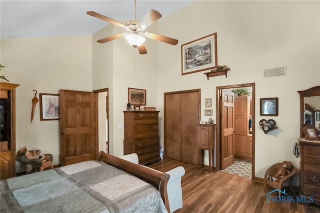 bedroom featuring high vaulted ceiling, ceiling fan, hardwood / wood-style flooring, and connected bathroom