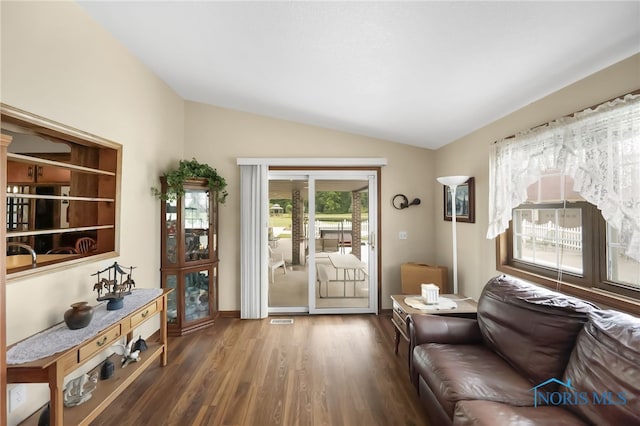 living room with lofted ceiling and dark hardwood / wood-style floors