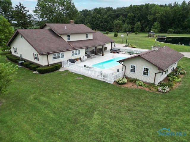 view of swimming pool with a lawn and a patio