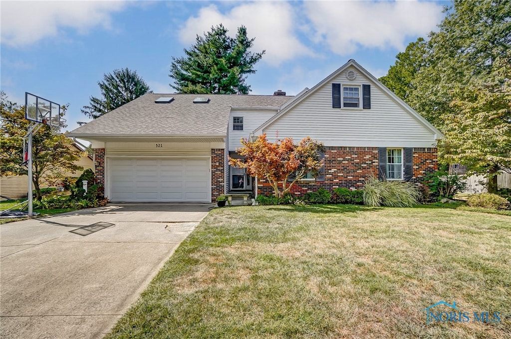 view of front facade with a front yard and a garage