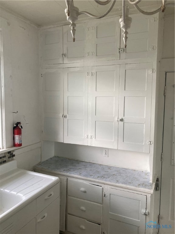 laundry room featuring cabinets