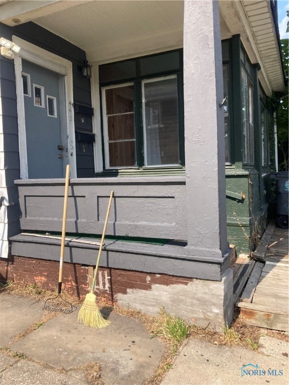 view of exterior entry with a porch