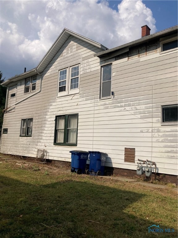 rear view of house with a yard