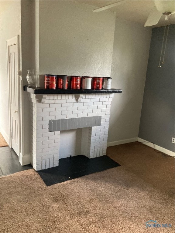 interior details featuring a fireplace and carpet flooring