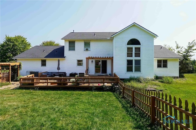 back of house with a pergola, a deck, and a lawn