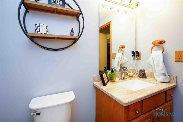 half bathroom with vanity and toilet