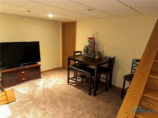 dining area featuring baseboards, a paneled ceiling, and carpet