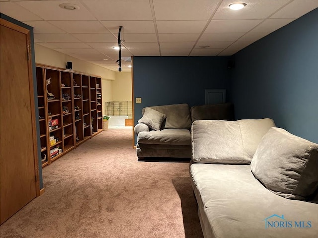 living room with a drop ceiling and carpet flooring