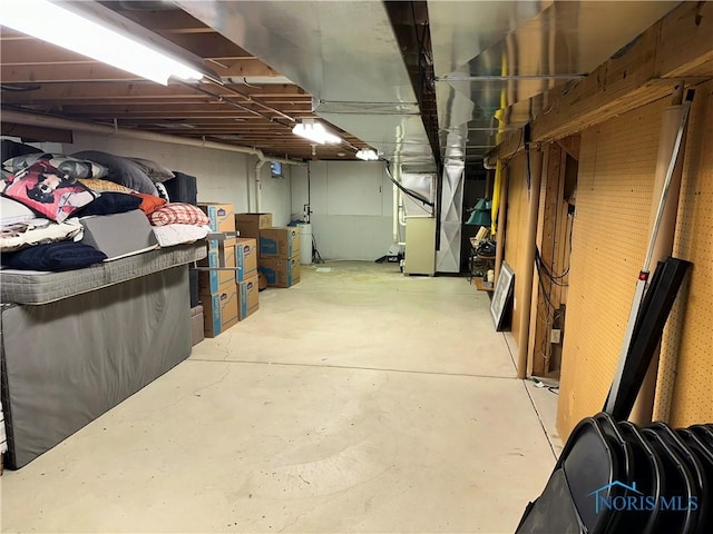 unfinished below grade area featuring heating unit