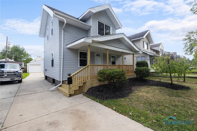 view of front facade featuring a garage, covered porch, a front lawn, and an outbuilding