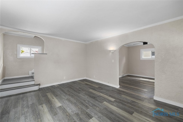 interior space with ornamental molding and dark hardwood / wood-style flooring