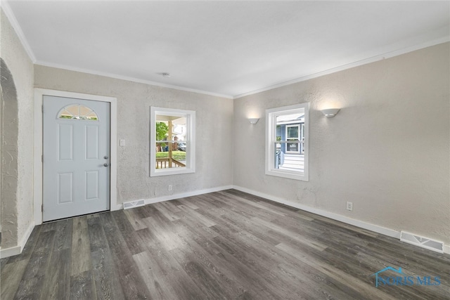 foyer with ornamental molding and dark hardwood / wood-style flooring