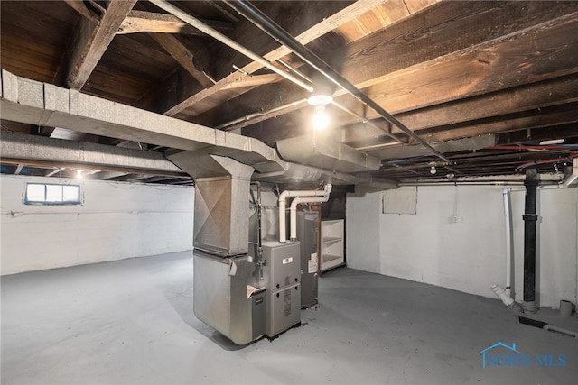 basement with electric water heater and heating unit