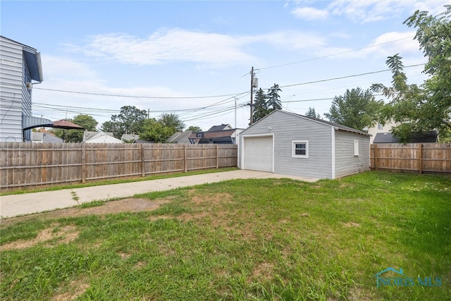 view of yard featuring an outbuilding and a garage