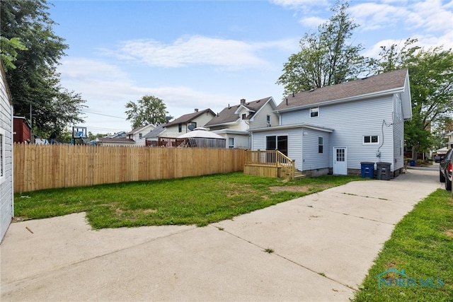 back of house with a lawn