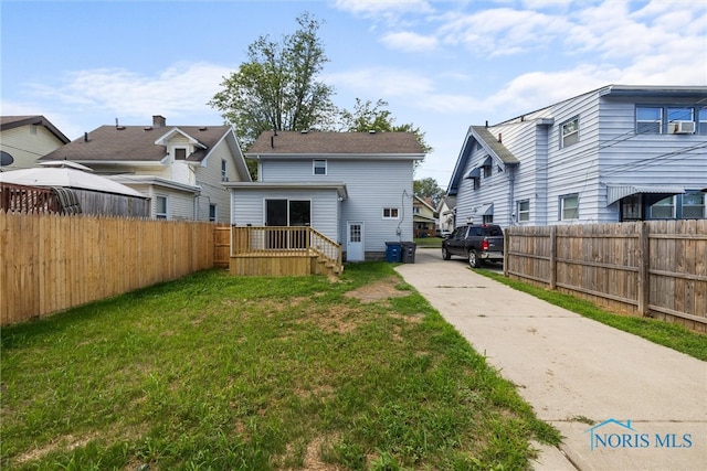 back of house featuring a yard