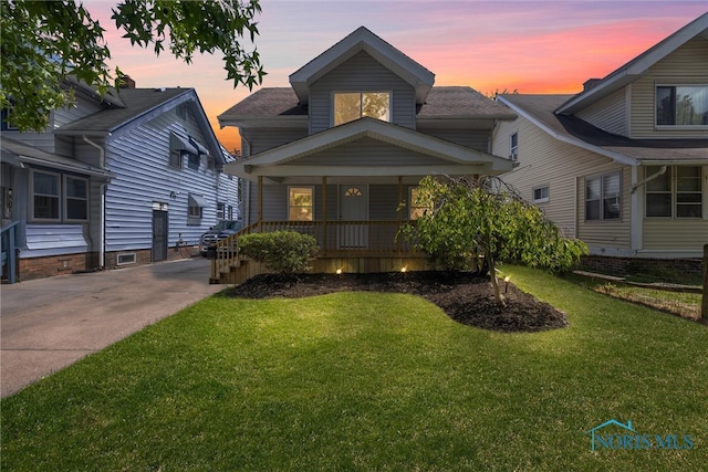 view of front of home with a yard and a porch