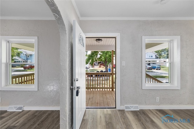 entryway with dark wood-type flooring and ornamental molding