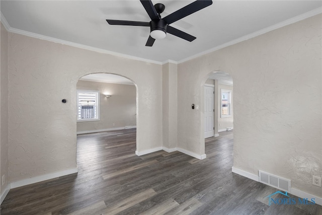 empty room with ornamental molding, ceiling fan, and dark hardwood / wood-style floors