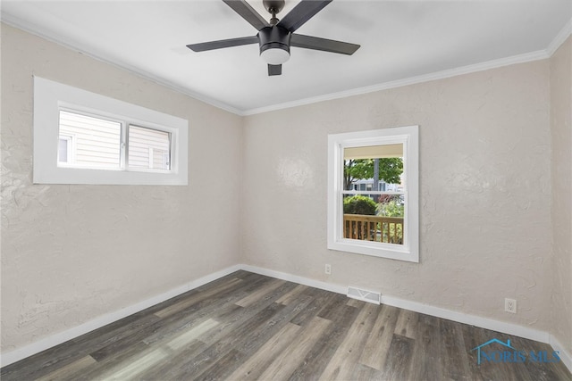 empty room with ceiling fan, dark hardwood / wood-style flooring, and crown molding