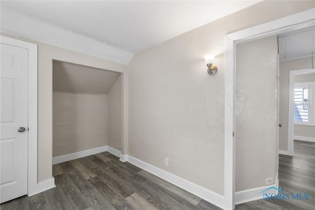 additional living space featuring dark hardwood / wood-style flooring and vaulted ceiling