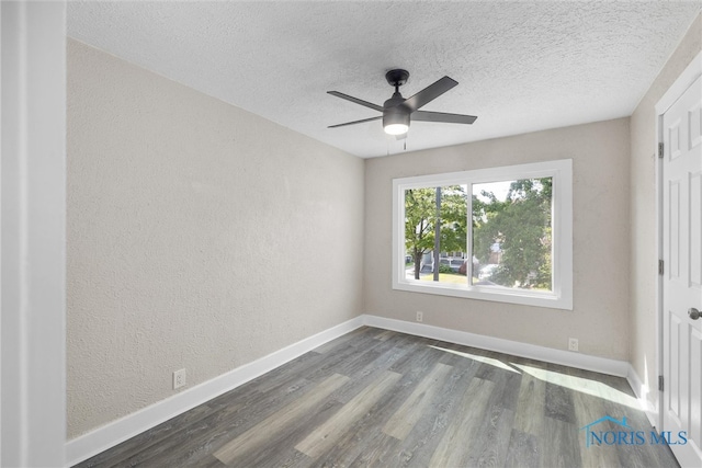 unfurnished bedroom with ceiling fan, dark hardwood / wood-style flooring, and a textured ceiling