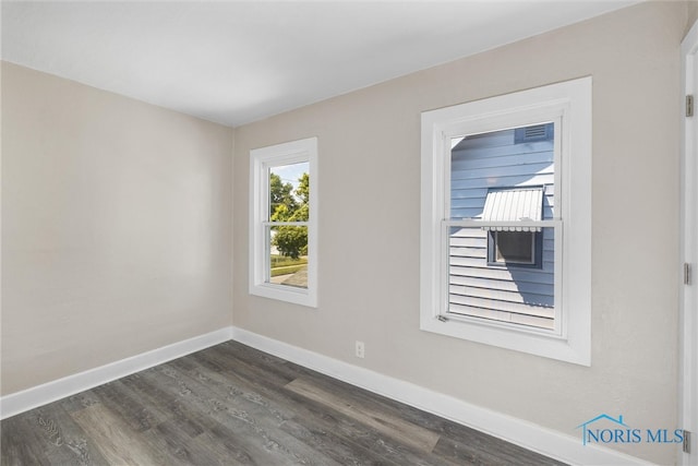 unfurnished room featuring dark wood-type flooring