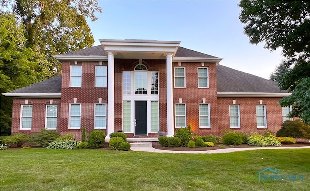 neoclassical / greek revival house with a front yard