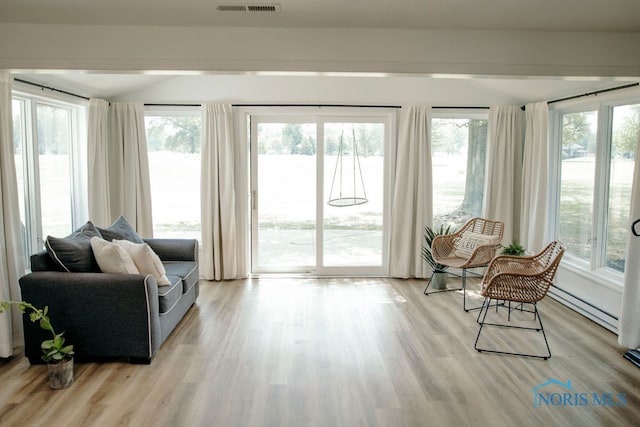 sunroom / solarium with a baseboard heating unit