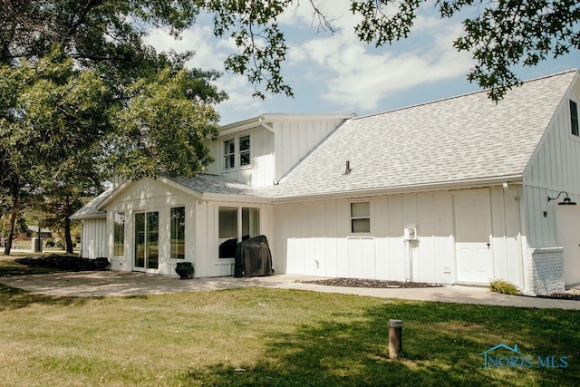 back of house featuring a yard and a patio