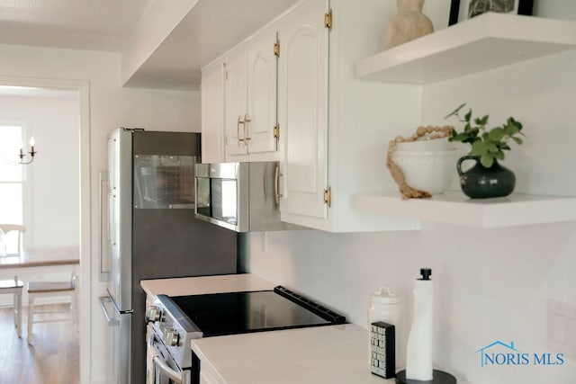 kitchen featuring appliances with stainless steel finishes and white cabinets