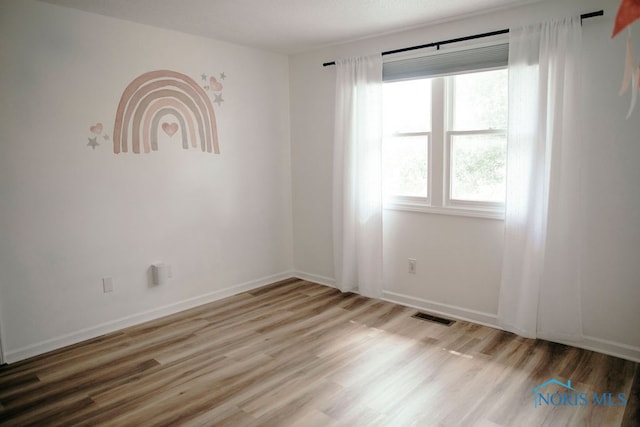 spare room featuring light hardwood / wood-style flooring