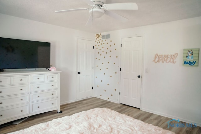 bedroom with light hardwood / wood-style flooring and ceiling fan