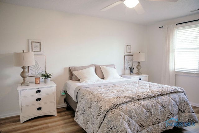 bedroom with hardwood / wood-style flooring and ceiling fan