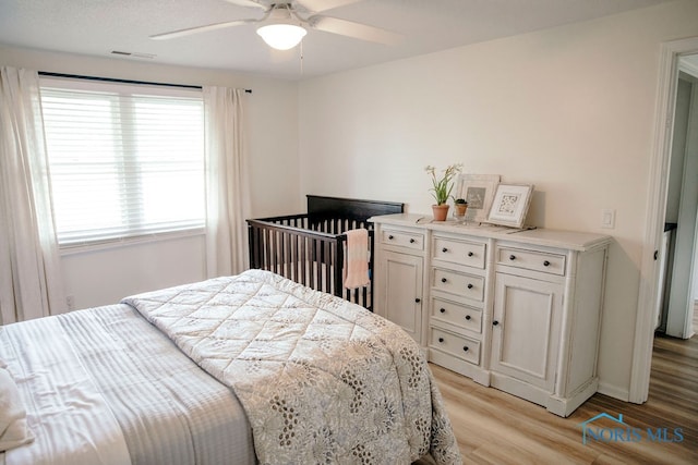 bedroom featuring multiple windows, ceiling fan, and light hardwood / wood-style floors