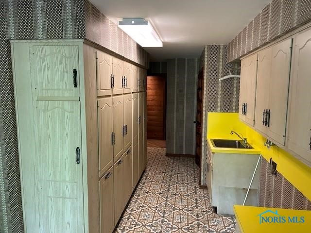 kitchen featuring sink and light tile patterned flooring